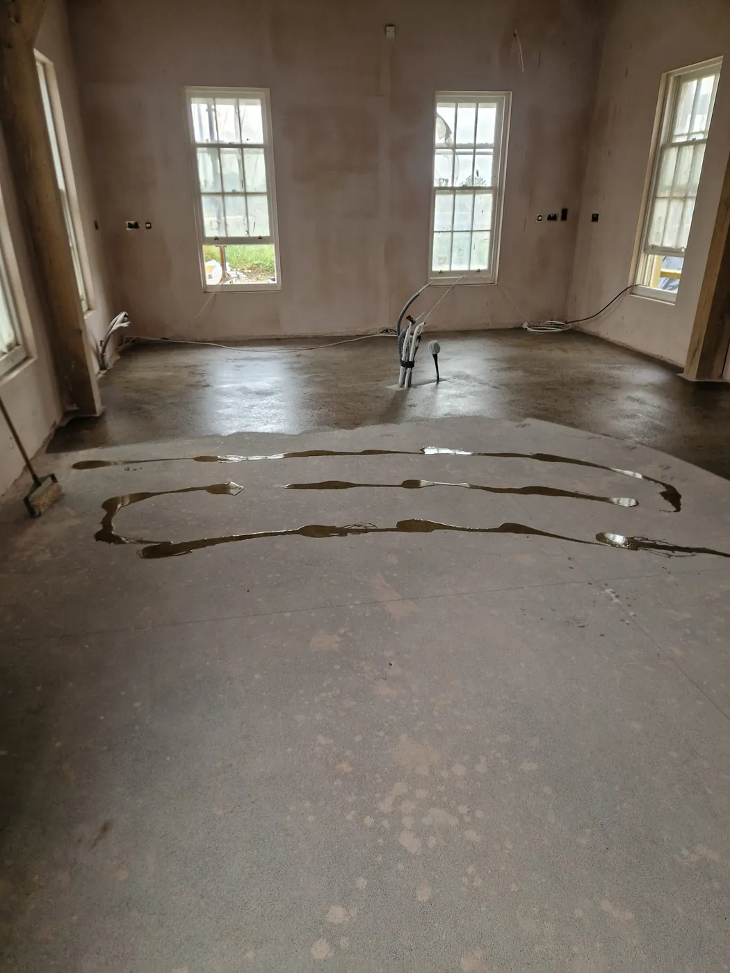 Bare concrete subfloor with levelling compound applied, before flooring