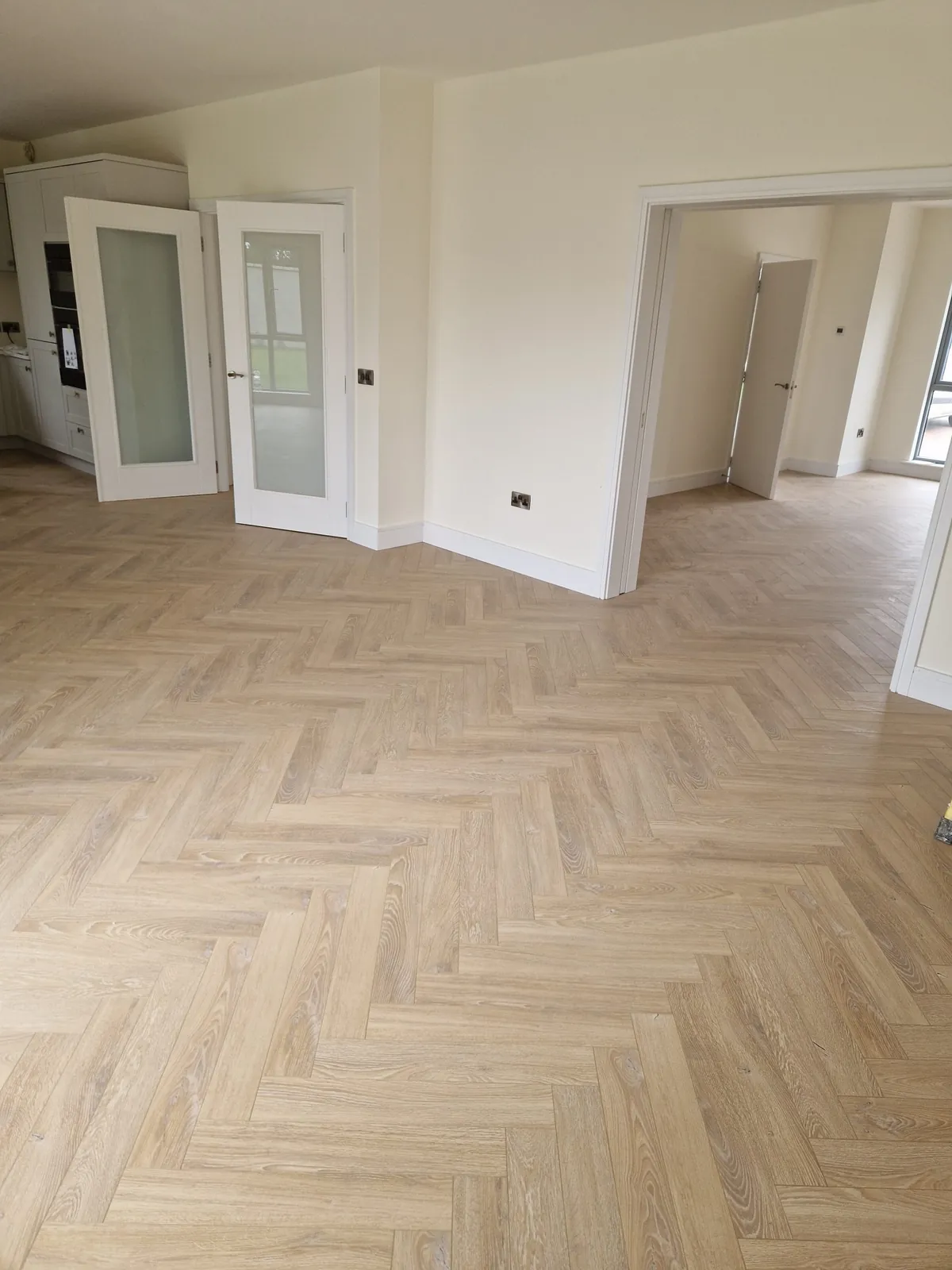 Herringbone flooring in a bright reception room