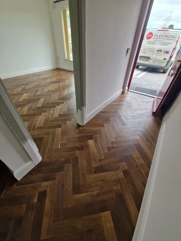 Rich dark herringbone flooring in an entrance hall during installation