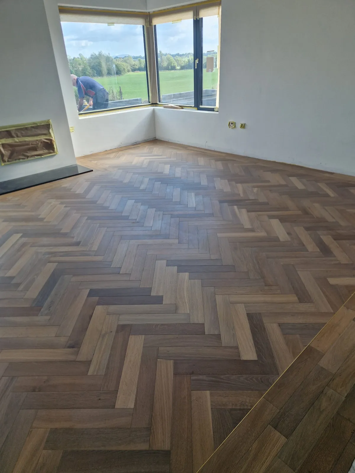 Herringbone flooring in a bright reception room