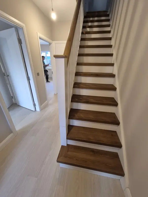 Renovated staircase with dark timber treads and white painted risers