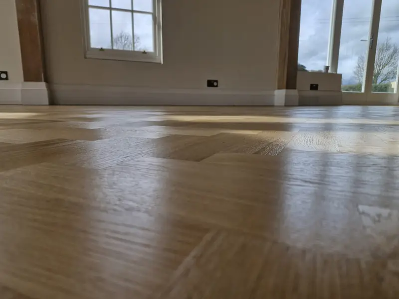 Sanded and refinished plank floor with a glossy protective finish
