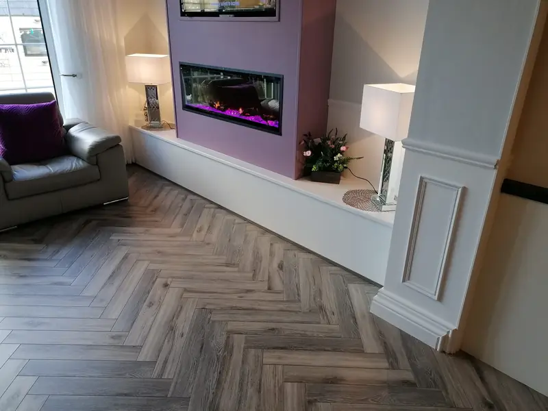 Herringbone LVT flooring in a living room with a feature fireplace
