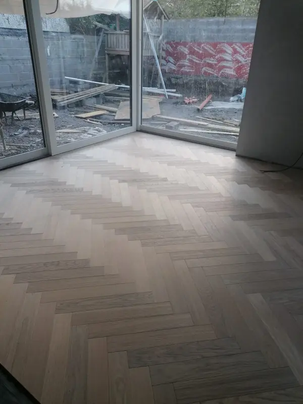 Grey herringbone LVT laid up to full-height patio doors