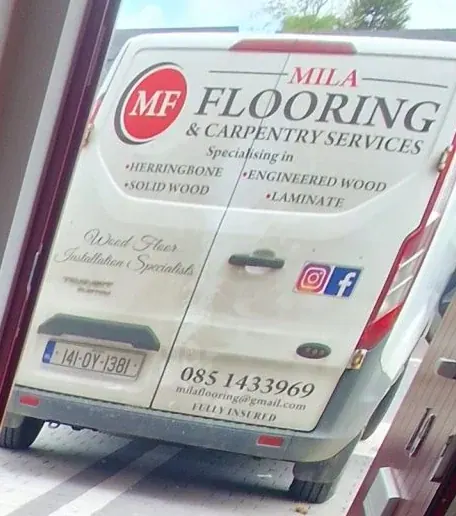 The Mila Flooring and Carpentry van, signwritten with the company name, herringbone, solid wood, engineered wood and laminate, the phone number and fully insured